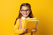 Young school girl happy with book, yellow background, Generative AI