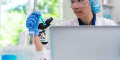 Scientist wearing glassware research in chemistry laboratory for pharmaceutical using beaker and test tube equipment for analysis microbiology