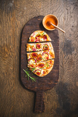 Wall Mural - French Tarte Flambee (Flammkuchen) with figs, red onions, soft goat cheese and honey