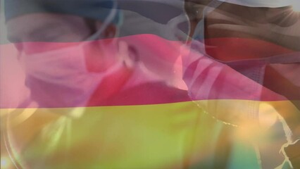 Canvas Print - Animation of germany flag against diverse male and female surgeon performing operation at hospital