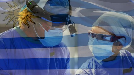 Poster - Animation of uruguay flag against diverse male and female surgeons performing operation at hospital