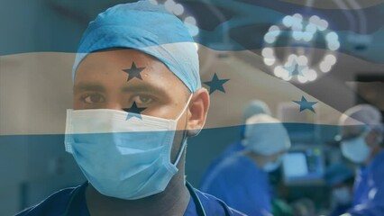 Poster - Animation of honduras flag against portrait of biracial male surgeon in surgical mask at hospital