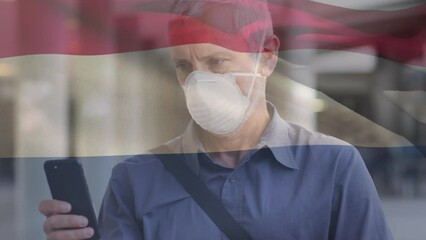 Poster - Animation of waving netherlands flag over caucasian man in face mask using smartphone on the street