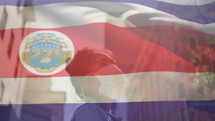 Poster - Animation of waving costa rica flag against asian woman wearing face mask on the street