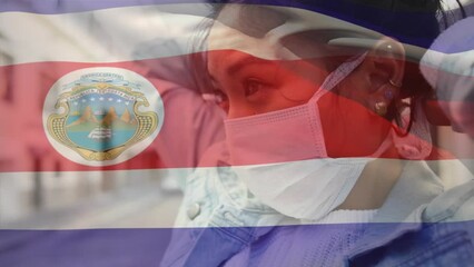 Poster - Animation of waving costa rica flag against asian woman wearing face mask on the street