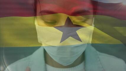Poster - Animation of waving ghana flag against portrait of asian woman wearing face mask on the street