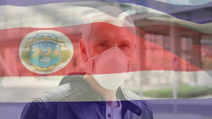 Poster - Animation of waving costa rica flag over portrait of caucasian man wearing face mask on the street