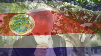 Poster - Animation of waving costa rica flag against caucasian man wearing face mask coughing on the street