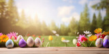 Fototapeta Sport - Wooden table with easter eggs and blurred spring meadow background