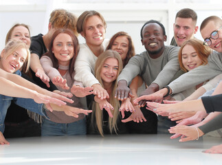 Wall Mural - multinational group of young people joining their palms