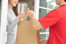 Postman, Service Shopping Online Asian Young Woman, Girl Hand Received Order, Delivery Man, Male Holding, Carrying Paper Bag Send To Customer House. Deliver, Courier Bring Product To Doorway At Home.
