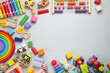 © New Africa - Frame of different children's toys on light grey background, flat lay. Space for text