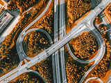 Fototapeta Na ścianę - Aerial view of highway and overpass with autumn color woods on a fall day in Finland.