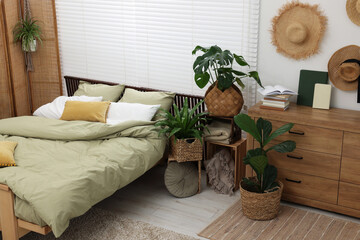 Sticker - Comfortable bed and beautiful green houseplants in bedroom