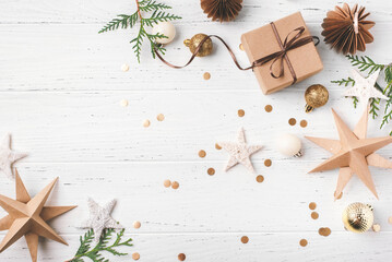 Wall Mural - Festive Christmas background with gift box and Christmas decorations on white wooden table. Top view. Copy space for text.