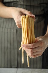 Woman with homemade pasta at table, closeup