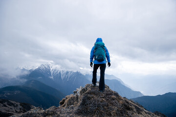 Wall Mural - Successful woman hiker hiking at mountain top in tibet