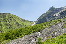 View Of The Valley Of Sofia Waterfalls With Green Mountain Slopes, Rocks And Waterfalls