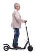 © ASDF - side view. modern elderly woman with electric scooter
