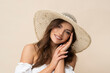 © forma82 - Very beautiful young woman in straw hat and white boho dress on creamy background.