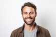 © Robert MEYNER - portrait of a confident Polish man in his 30s wearing a chic cardigan against a white background