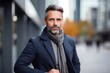 © Robert MEYNER - portrait of a confident Polish man in his 40s wearing a chic cardigan against a modern architectural background