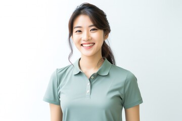 Canvas Print - Portrait of a Japanese woman in her 20s wearing a sporty polo shirt against a white background