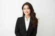 Portrait of a confident Japanese woman in her 30s wearing a sleek suit against a white background