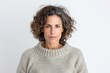 © Leon Waltz - medium shot portrait of a serious, Israeli woman in her 40s wearing a cozy sweater against a white background
