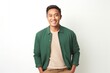 © Anne-Marie Albrecht - medium shot portrait of a happy Filipino man in his 30s wearing a chic cardigan against a white background