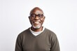 © Anne-Marie Albrecht - medium shot portrait of a happy Kenyan man in his 50s wearing a chic cardigan against a white background