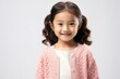 © Anne-Marie Albrecht - medium shot portrait of a happy Filipino child female wearing a chic cardigan against a white background