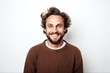 © Anne-Marie Albrecht - medium shot portrait of a happy Polish man in his 30s wearing a chic cardigan against a white background
