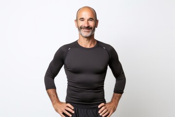 portrait of a Israeli man in his 40s wearing a pair of leggings or tights against a white background