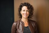 Fototapeta  - portrait of a Israeli woman in her 40s wearing a chic cardigan against an abstract background