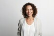 © Anne-Marie Albrecht - medium shot portrait of a confident Israeli woman in her 40s wearing a chic cardigan against a white background