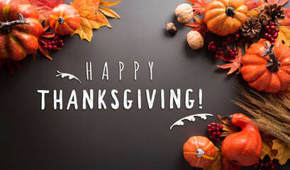 Wall Mural - thanksgiving and autumn decoration concept made from autumn leaves and pumpkin on dark background. f