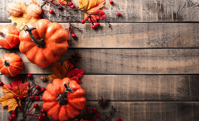 Wall Mural - autumn and thanksgiving decoration concept made from autumn leaves and pumpkin on dark wooden backgr