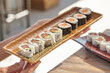 © ADDICTIVE STOCK CORE - Crop person with sushi set on plate