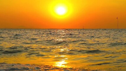 Wall Mural - close up to wave sunset red blue yellow sky with dark cloud over the sea and silhouette flag on bamb