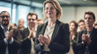 © Anna - Business people applauding during a meeting in a conference room. Focus on the woman