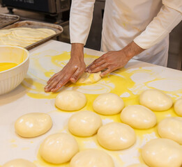 Wall Mural - A cook prepares bread from dough in a restaurant