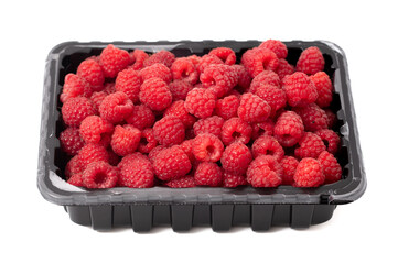 Canvas Print - Raspberry in a container isolated on a white background. Close-up