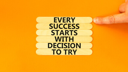 Wall Mural - Success symbol. Concept words Every success starts with decision to try on wooden stick. Beautiful orange background. Businessman hand. Business success and decision to try concept. Copy space.