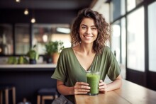 Beautiful Smiling Girl With A Green Smoothie Cocktail Sitting At A Table In A Cafe, Healthy Eating And Diet