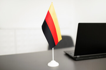 Poster - Flag Of Germany Standing Near Laptop On Desk In Office
