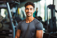 Portrait Of Young Indian Sporty Man In Gym. Happy Athletic Fit Muscular Man In Fitness Center.