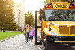 © Prostock-studio - Transportation Concept. Group of children getting on the yellow schoolbus