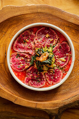 Wall Mural - beef carpaccio on the wooden background