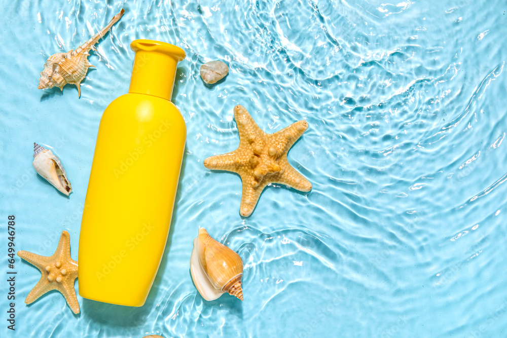 Sunscreen cream with starfishes and seashells in water on color background